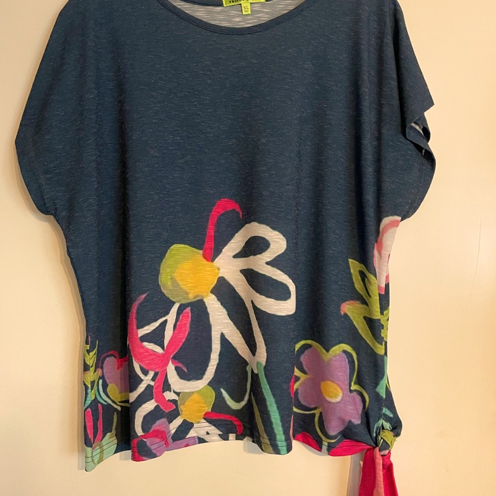 Blue XL top with flower on bottom.